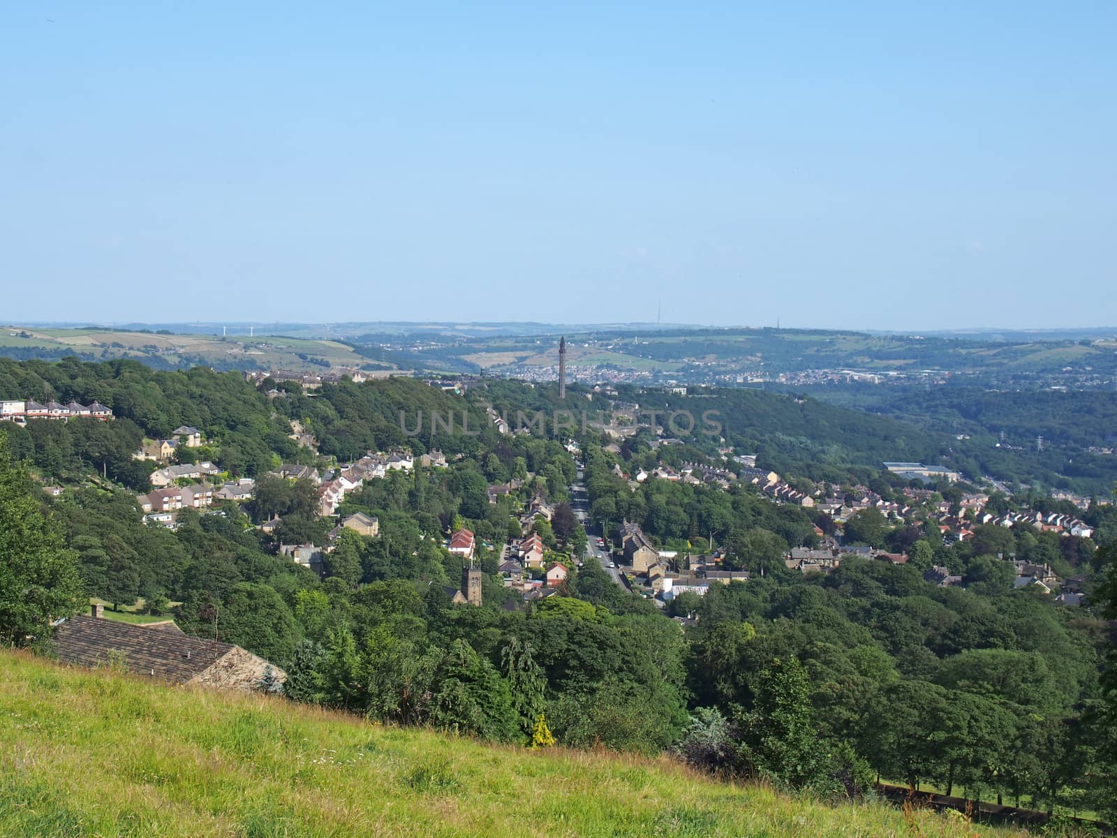 a view of the town of halifax from high west yorkshire countryside surrounded by trees fields and nearby villages