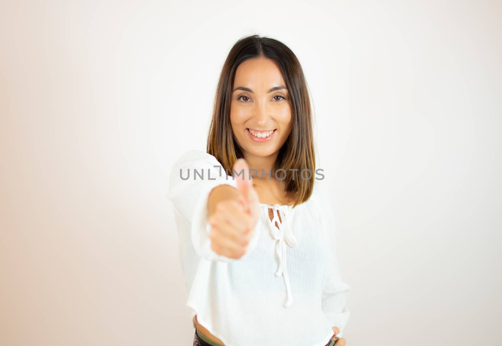 Beautiful young woman in white shirt smiling