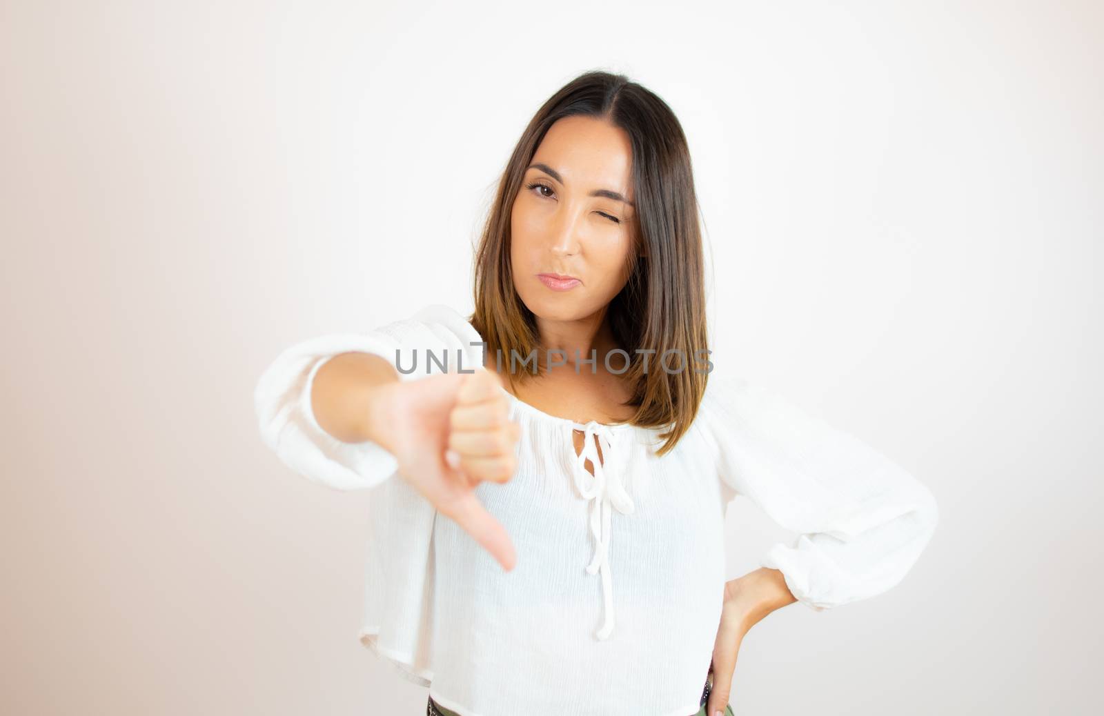 Beautiful young woman in white shirt gesturing