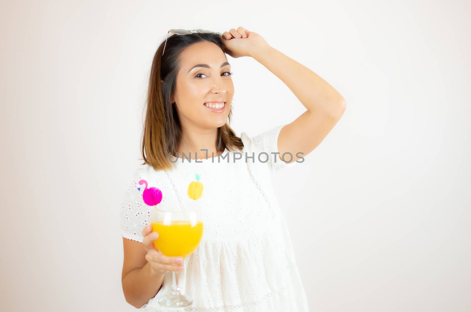 Beautiful young woman smiling with a cocktail by lmstudio