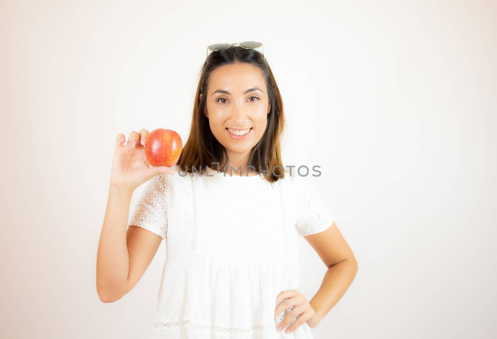 Beautiful young woman picking up an apple by lmstudio