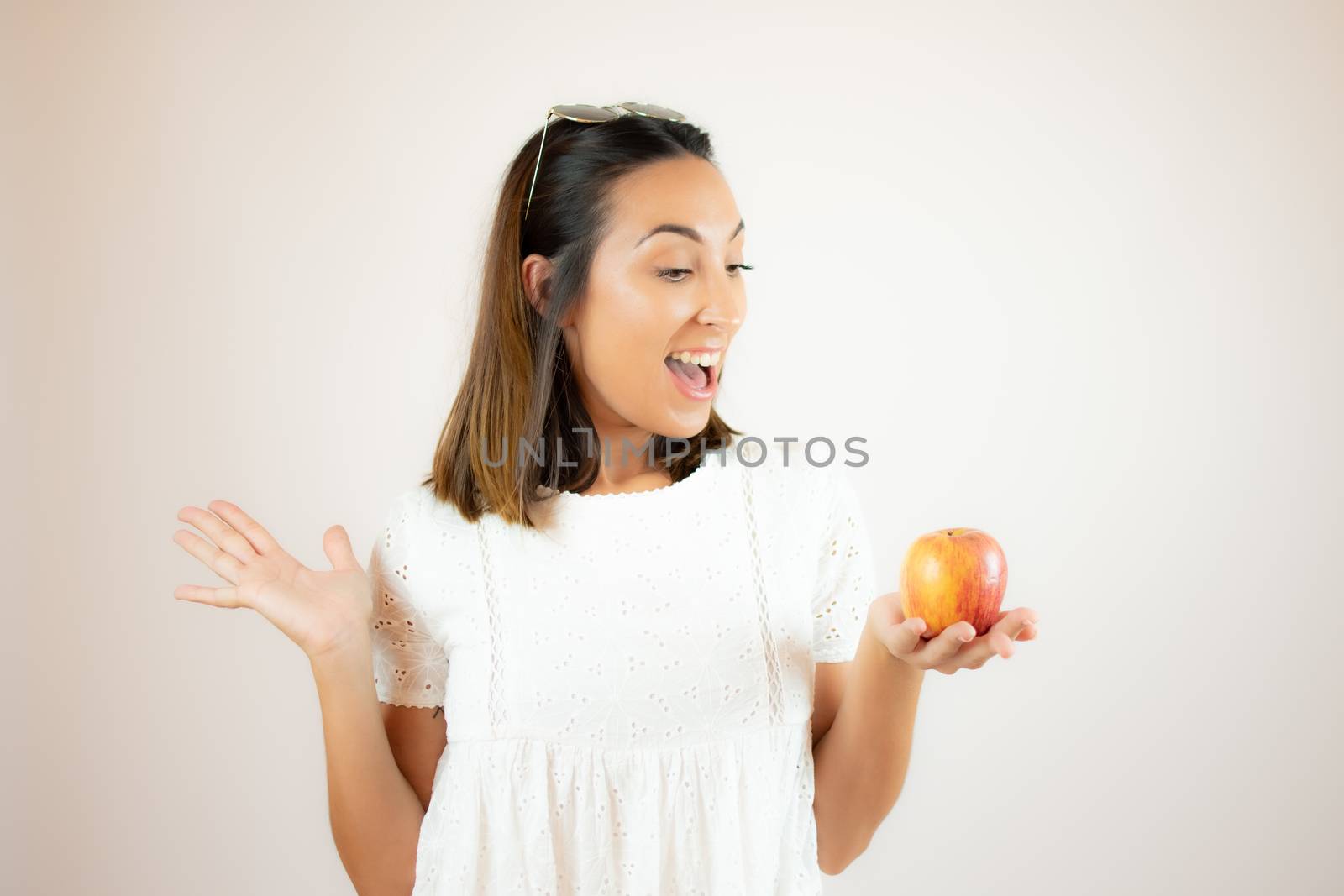 Beautiful young woman picking up an apple by lmstudio