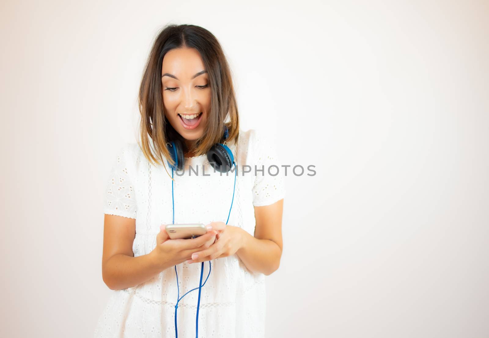Beautiful woman in white dress with headphones