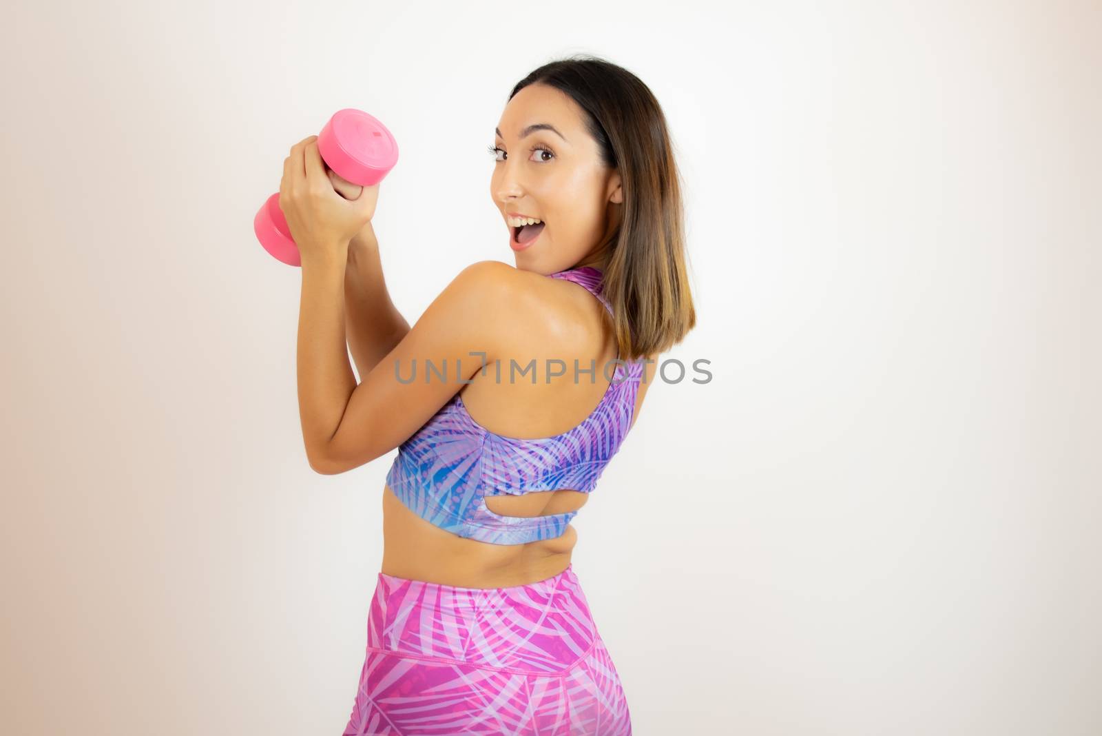 Beautiful woman with sports clothes with a dumbbell