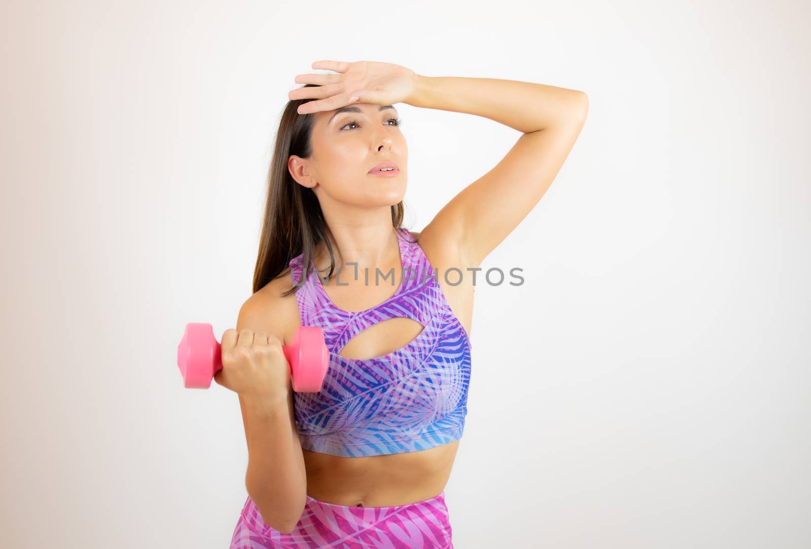 Beautiful woman with sports clothes with a dumbbell by lmstudio