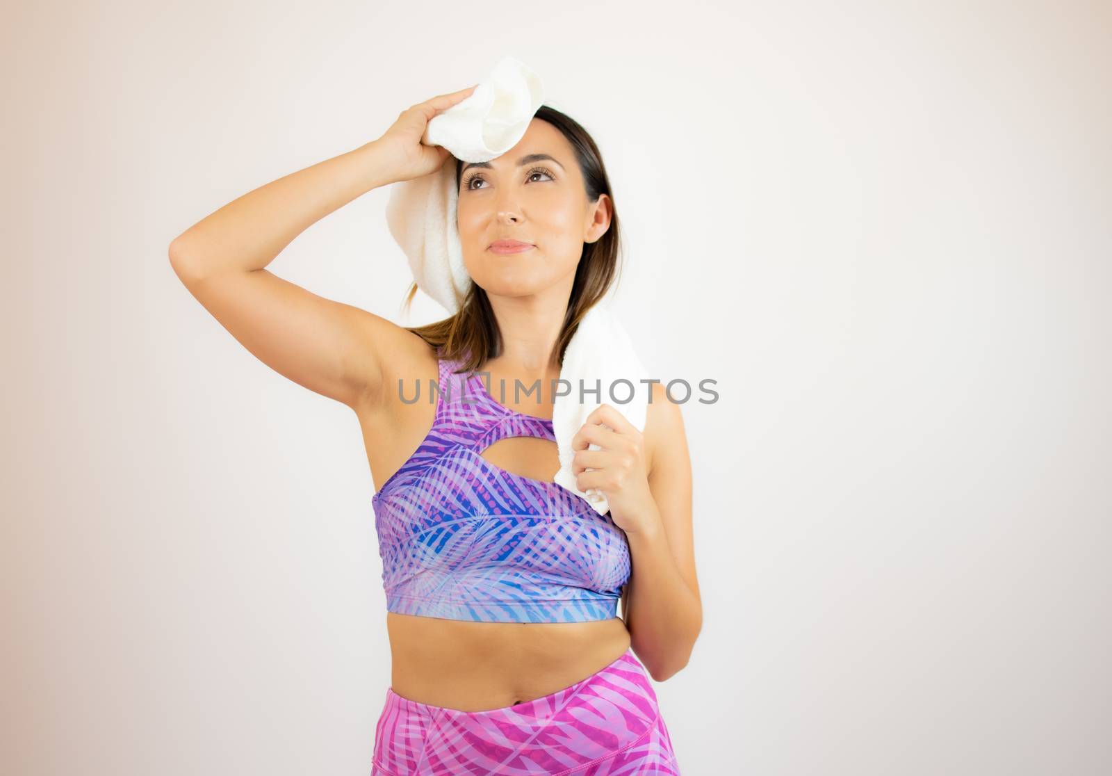 Beautiful woman with sports clothes with a towel