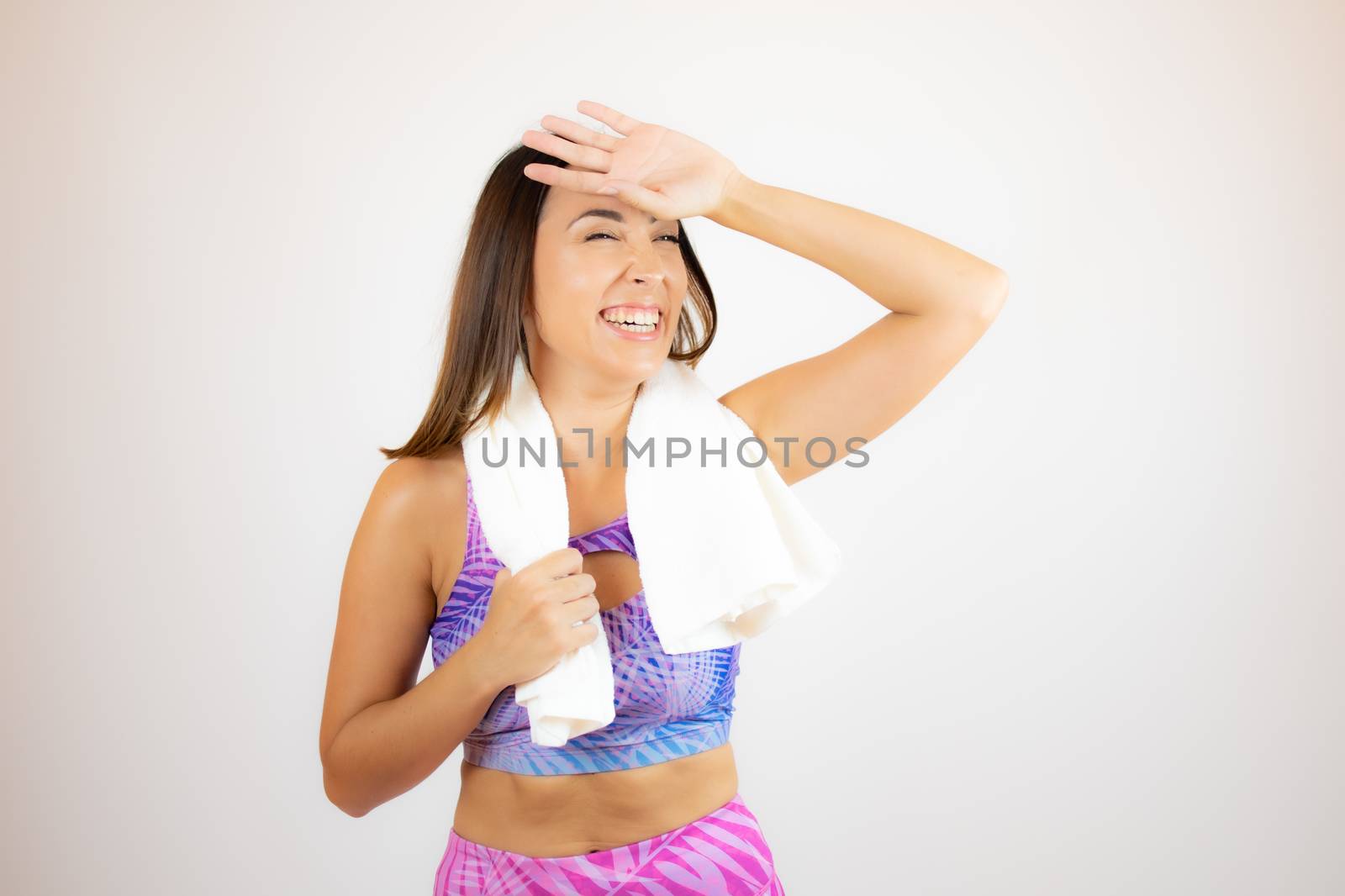 Beautiful woman with sports clothes with a towel by lmstudio