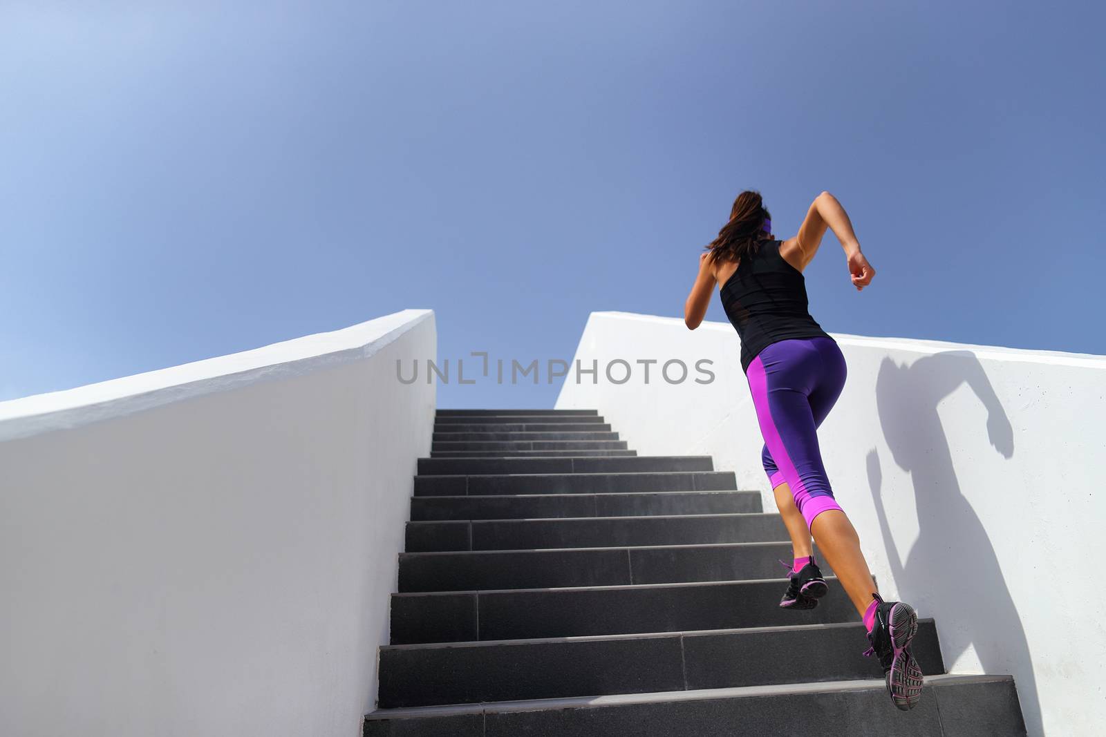 Stairs running workout woman training cardio at gym. Fitness girl exercising legs muscles outdoors with explosive exercises by Maridav