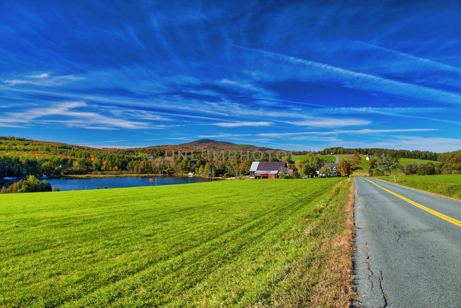 Road across New England countryside in foliage season, USA by jovannig