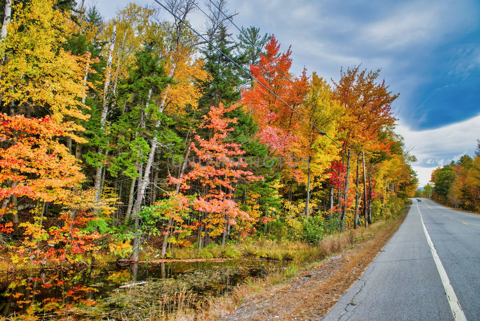 Road across New England countryside in foliage season, USA by jovannig