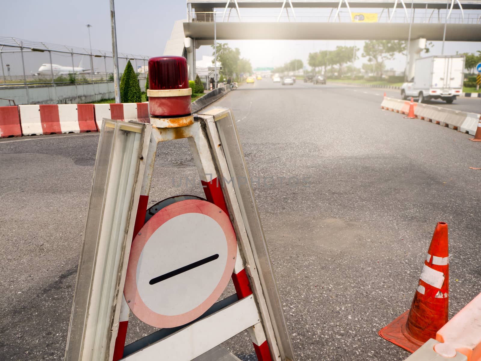 plastic road fencing on the street of a modern city by shutterbird