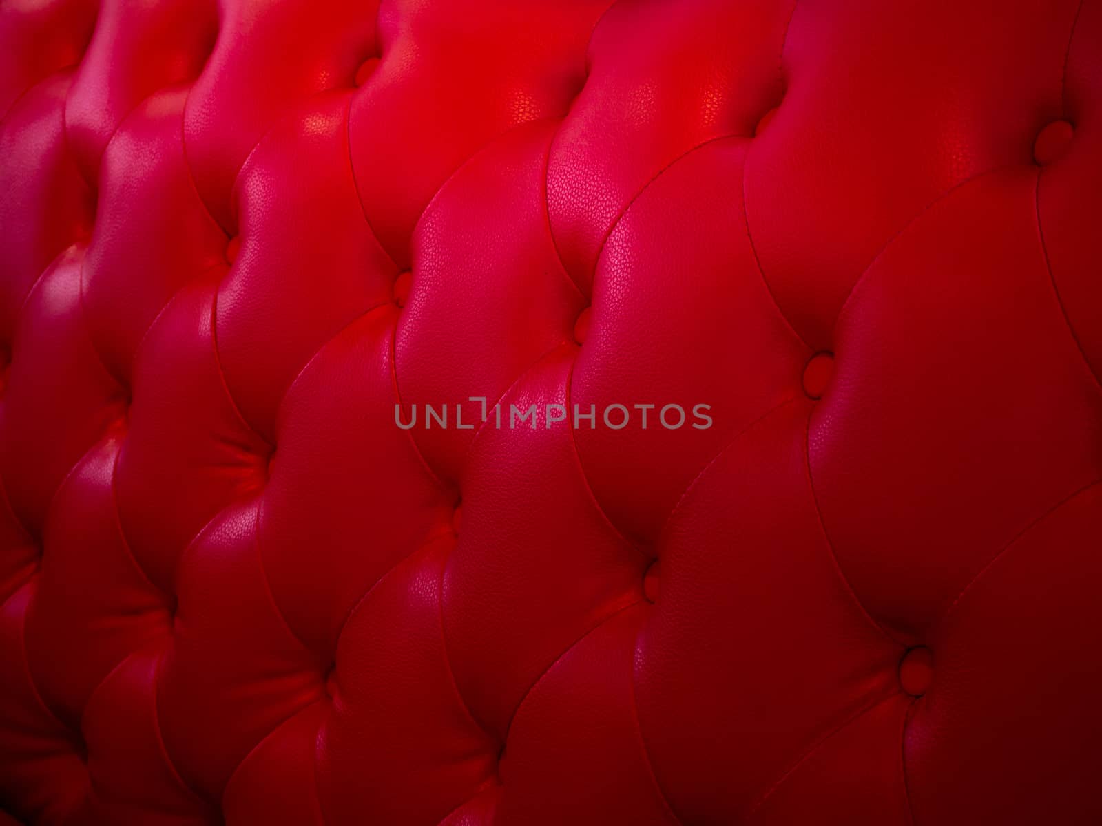 Background from leather of cushion. Red leather from retro chairs. The seat has a vintage style texture