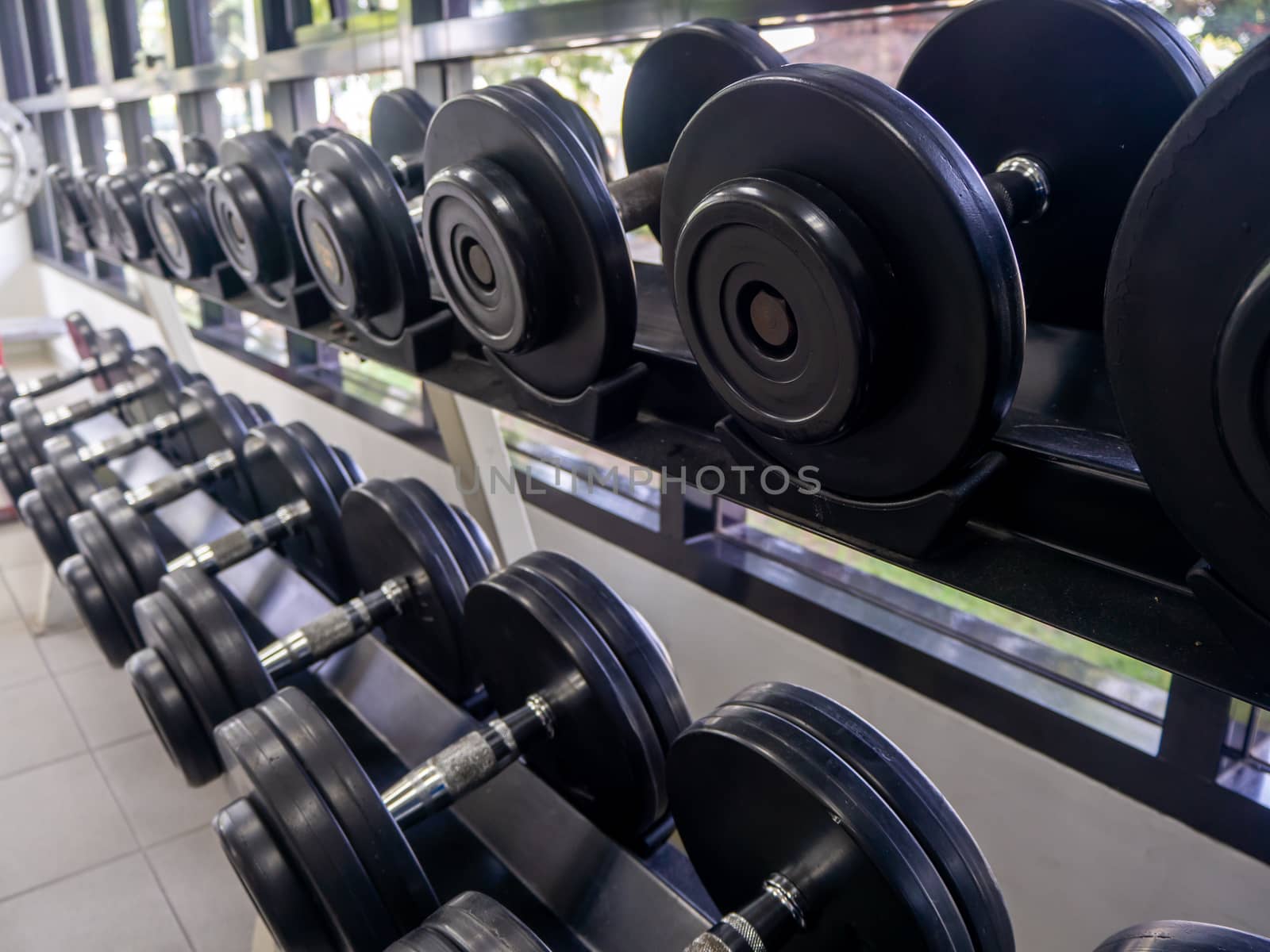 dumbbell set. Close up many metal dumbbells by shutterbird