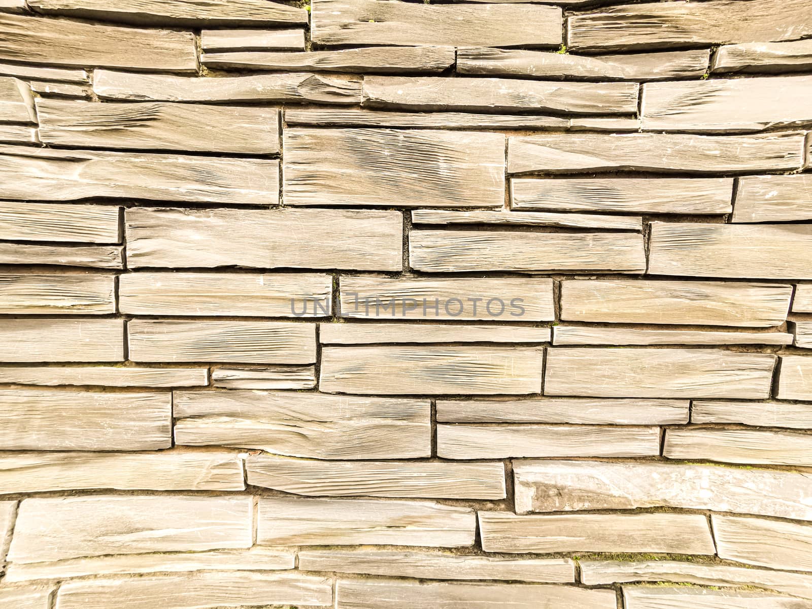 Wall made of light color stone or marble piled up. Light color stone wall background by sonandonures