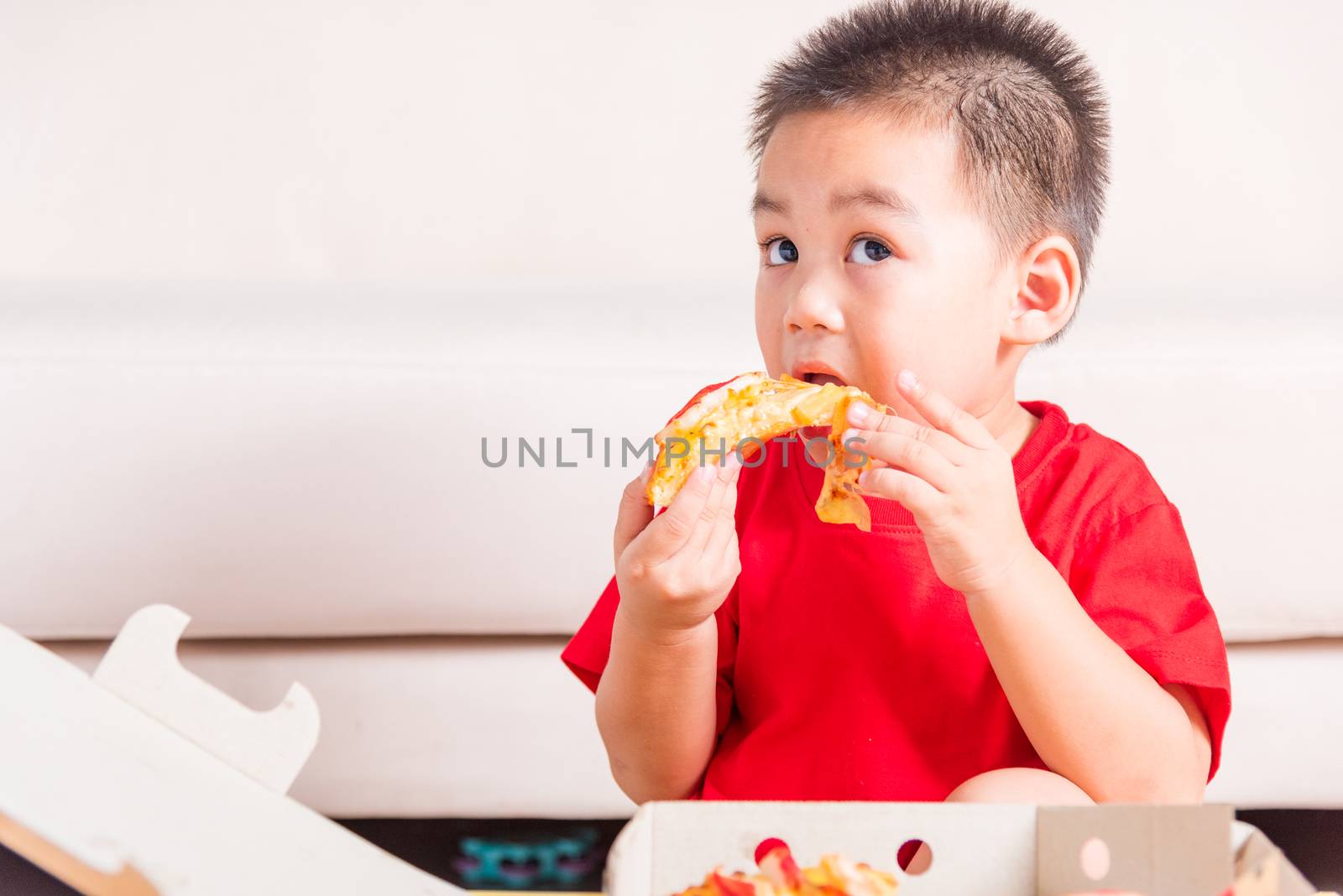 Hot Homemade, Vegetarian fast Italian food, Cute Little Child enjoying eating Delivery Pizza pepperoni, cheese many slices deliciously in an open cardboard box at home