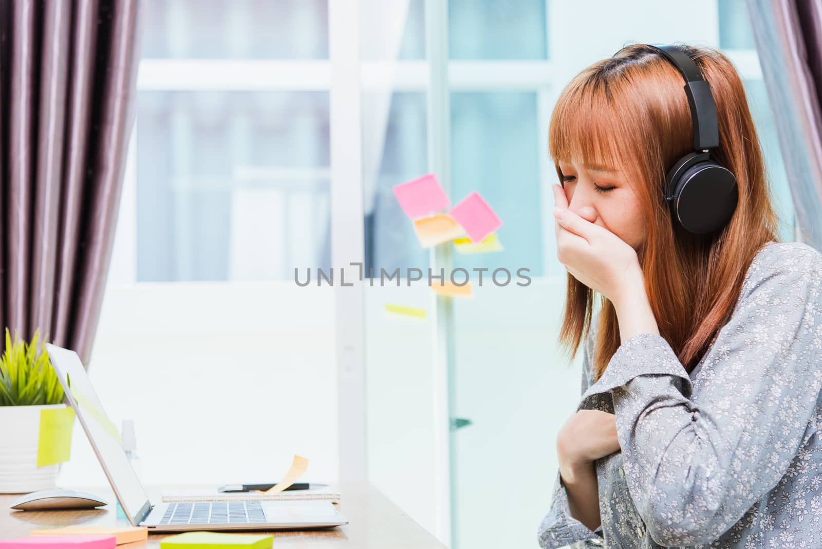 Work from home concept, Asian beautiful young woman, student girl tired sleepy yawning use hand close mouth during working with laptop computer at home office