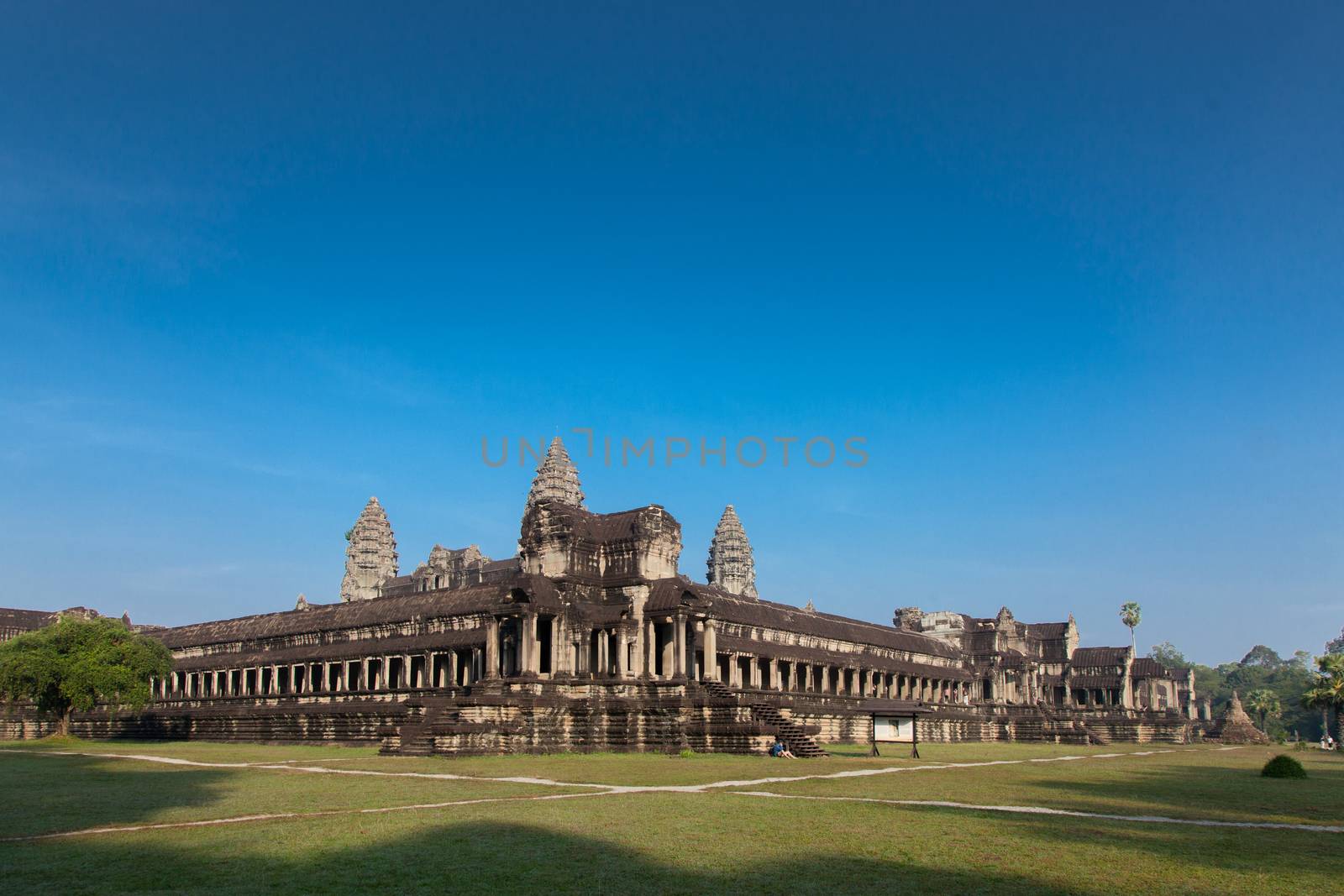The temple complex of Angkor Watt, Cambodia wide angle image with deep blue sky by kgboxford