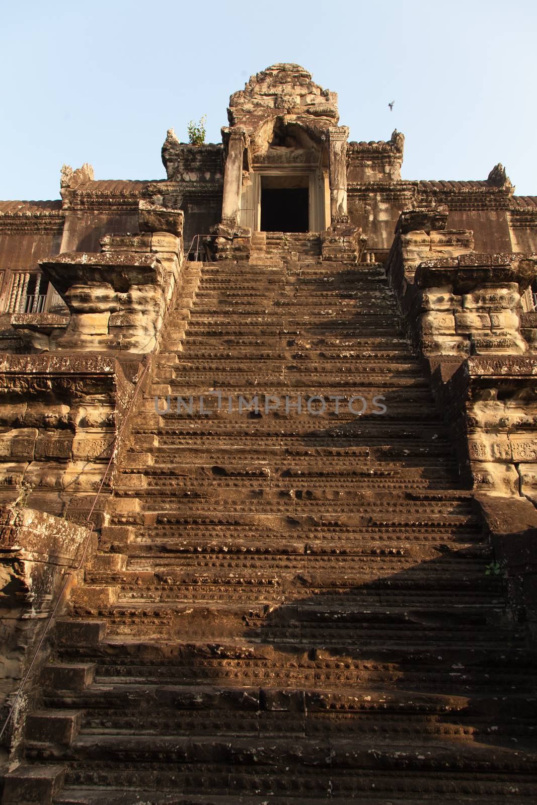 The temple complex of Angkor Watt, Cambodia, early morning sun looking at towers by kgboxford