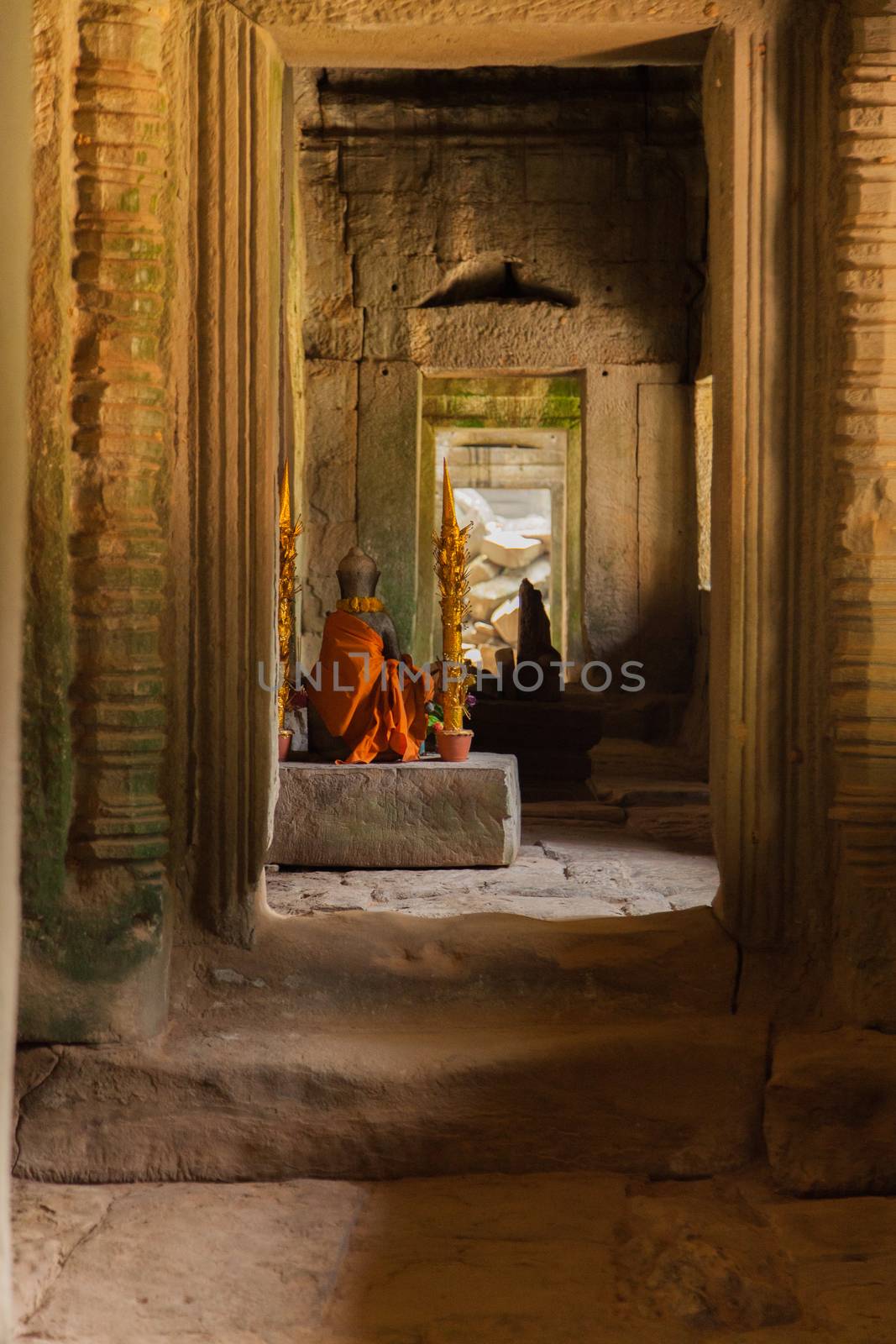 Important golden shrine in temple at Angkor Wat temples complex, shot through doorway with light illuminating the shrine. High quality photo