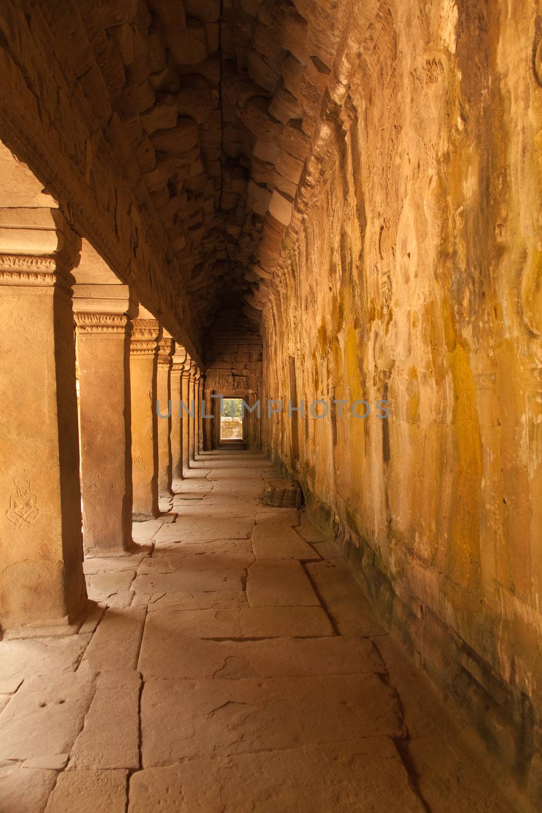 The temples of Angkor Watt, Cambodia, golden passageway with repeating arches by kgboxford