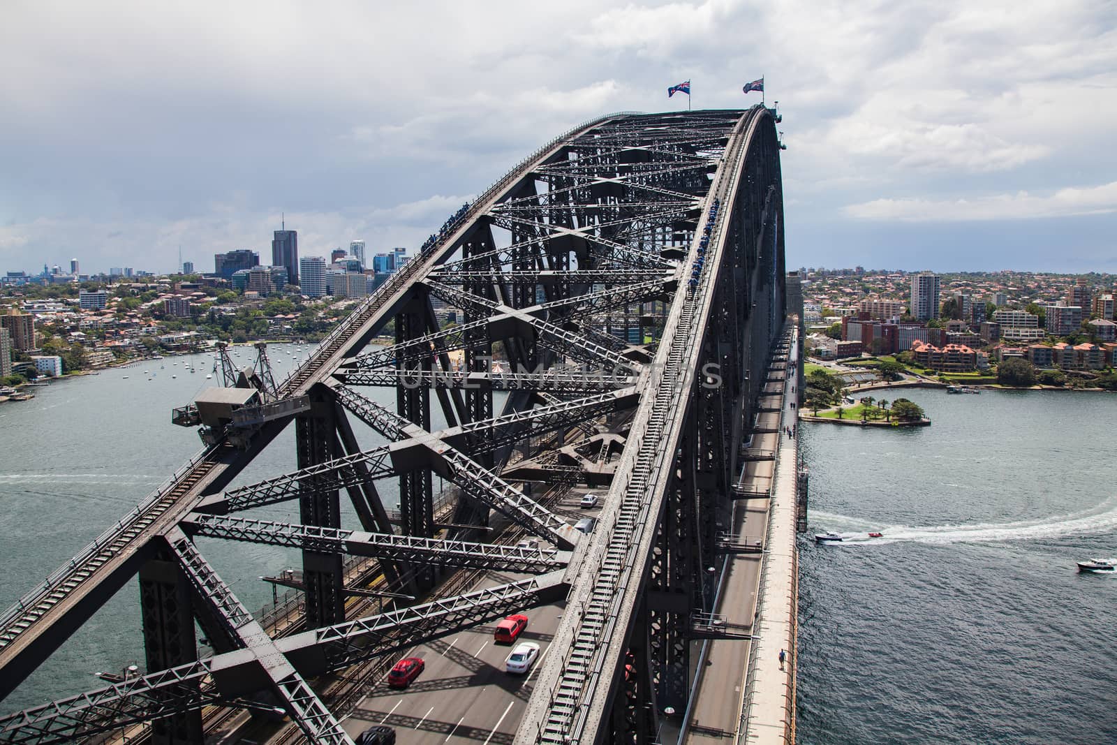 Sydney harbour with bridge structure in foreground. dramatic and unusual view of this landmark taken from one of the bridge pylons give a high angle view looking down the length of the bridgeHigh quality photo
