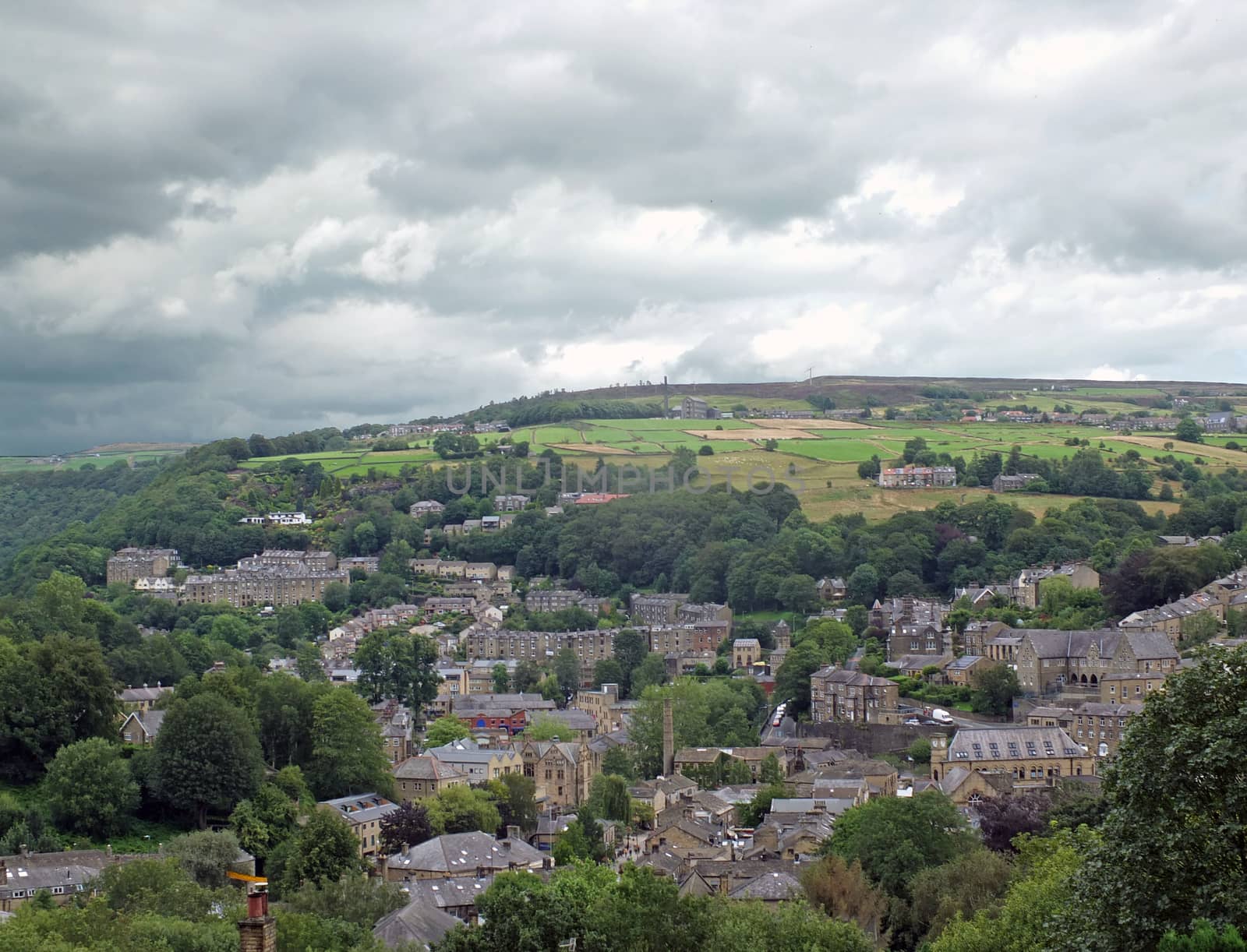 an aerial view of the town of hebden bridge in west yorkshire surrounded by pennine hills and fields by philopenshaw