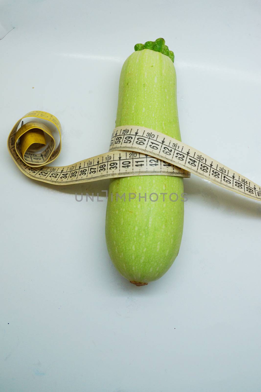 soft measuring linear zucchini wrapped around as a symbol of healthy eating