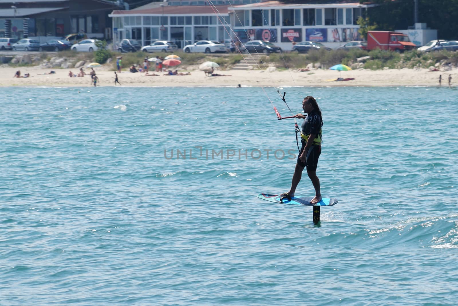 Varna, Bulgaria - July, 19, 2020: a man is kiting the sea against the background of the beachVarna