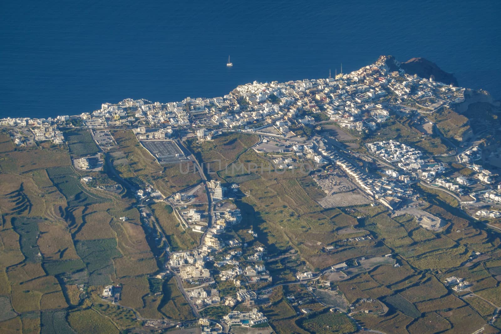 Aerial view of village on Santorini island, Greece from airplane.