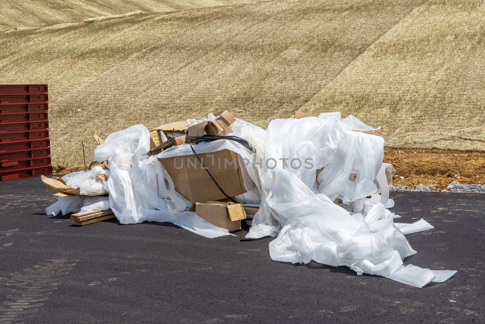 Horizontal shot of a trash pile on a commercial construction site.