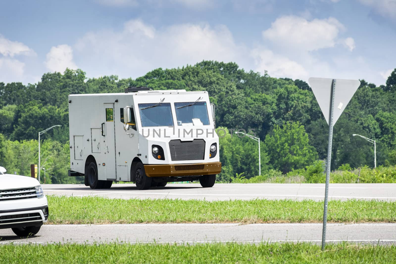 Horizontal shot of an unmarked armored car in traffic.