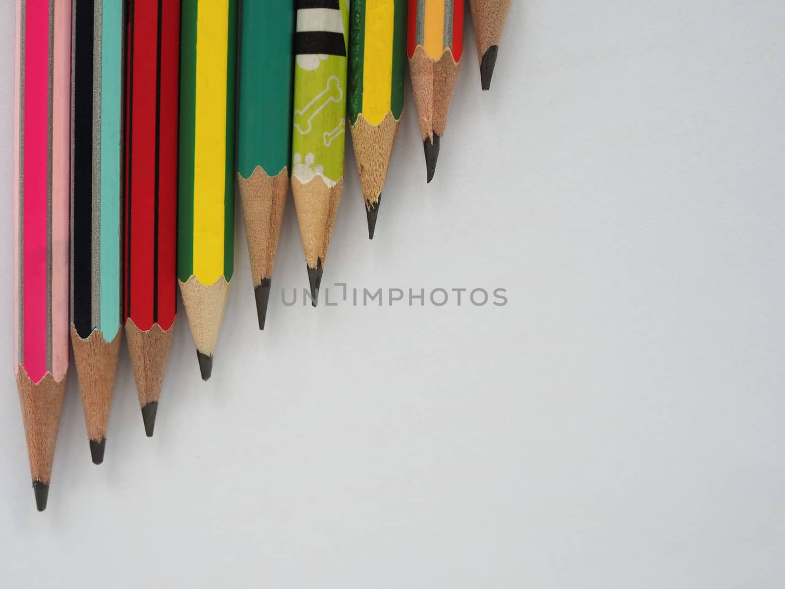 A pencil arranged in a row on a white background. by Unimages2527