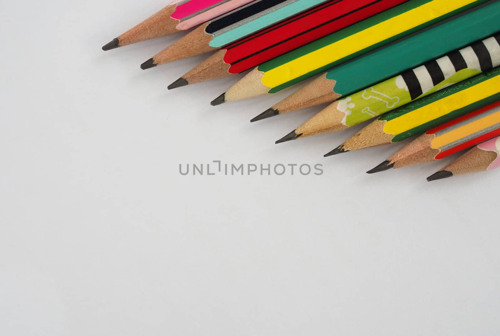 A pencil arranged in a row on a white background. by Unimages2527