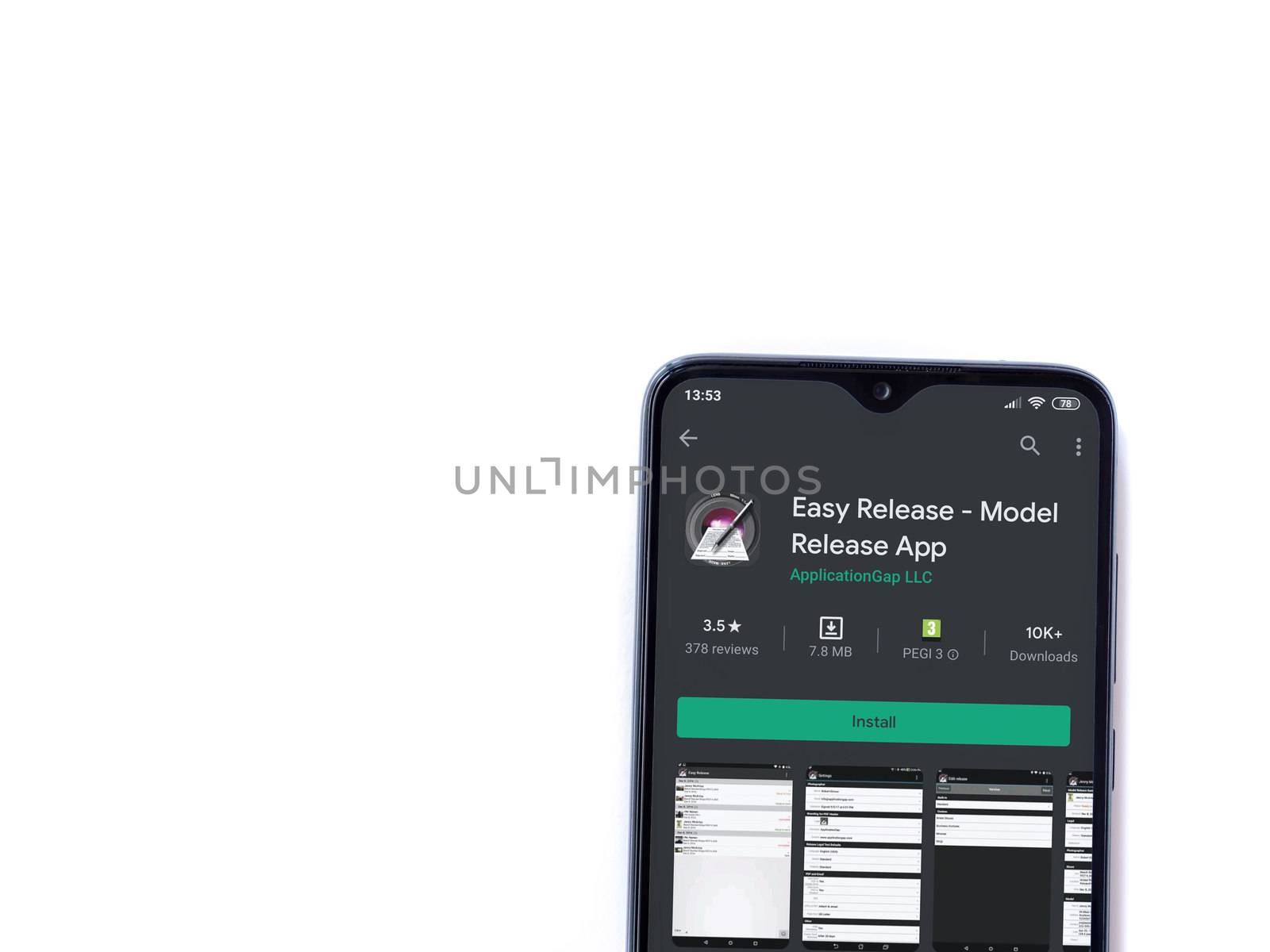 Lod, Israel - July 8, 2020: Easy Release Pro - Model Release app play store page on the display of a black mobile smartphone isolated on white background. Top view flat lay with copy space. 