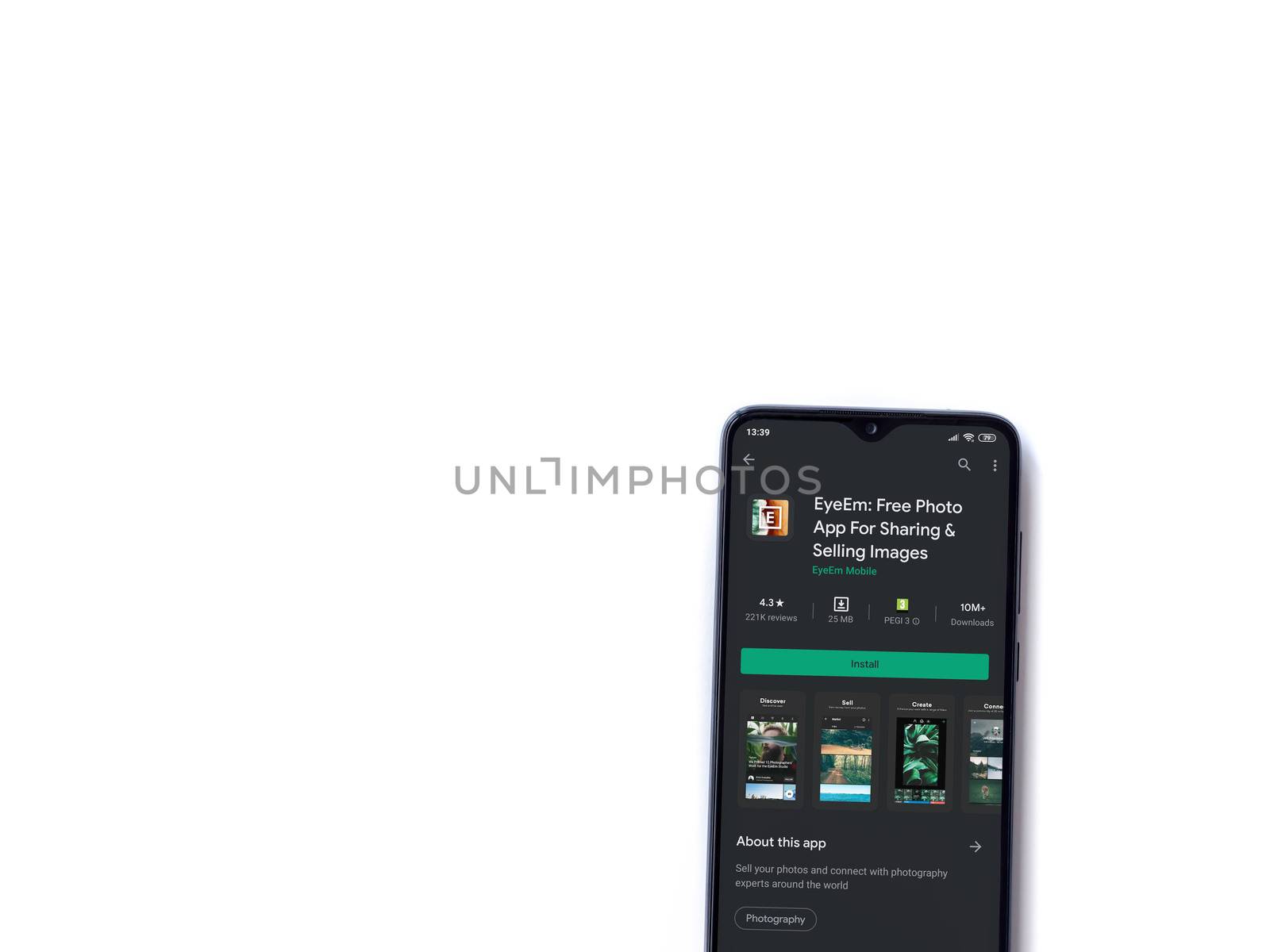 Lod, Israel - July 8, 2020: EyeEm - Sharing & Selling Images app play store page on the display of a black mobile smartphone isolated on white background. Top view flat lay with copy space.