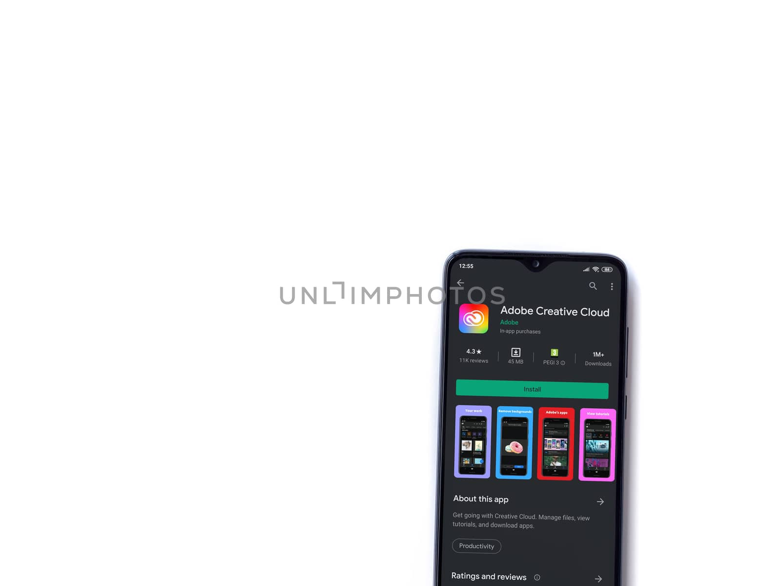 Lod, Israel - July 8, 2020: Adobe Creative Cloud app play store page on the display of a black mobile smartphone isolated on white background. Top view flat lay with copy space.