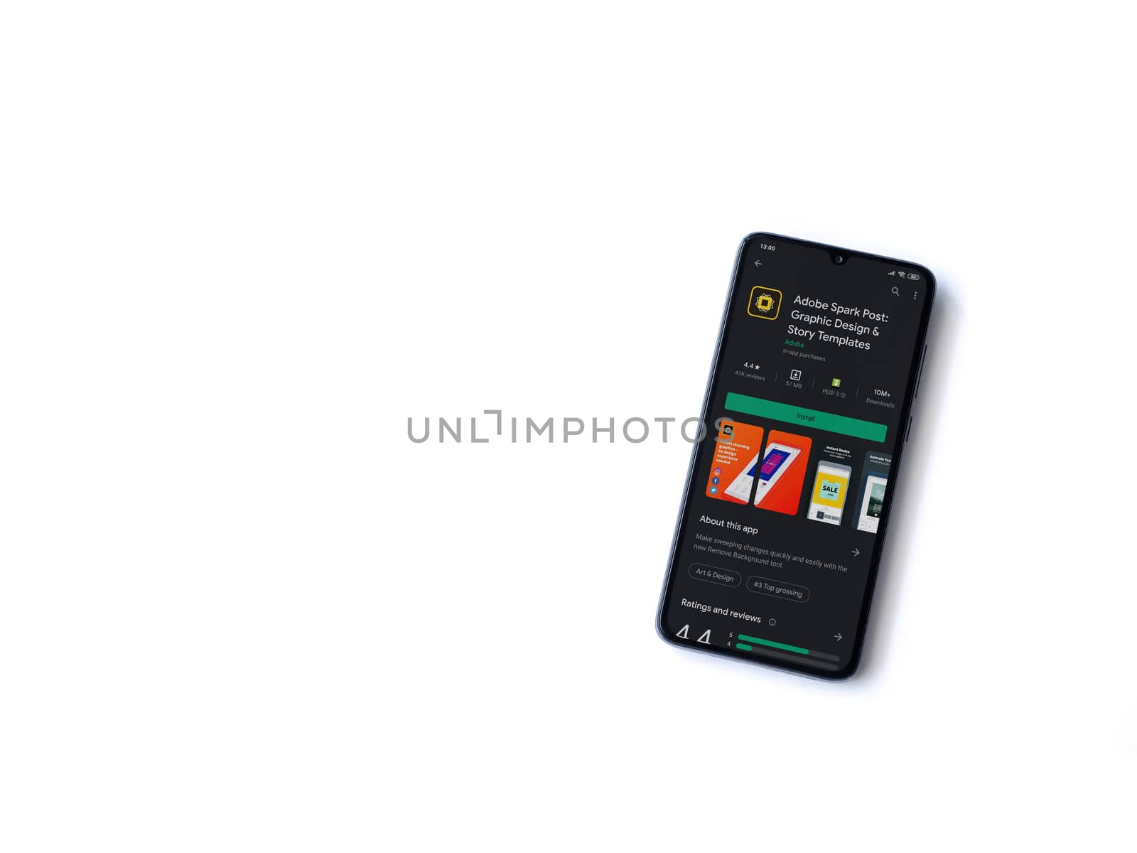 Lod, Israel - July 8, 2020: Adobe Spark Post - Graphic Design & Story Templates app play store page on the display of a black mobile smartphone on white background. Top view flat lay with copy space. 