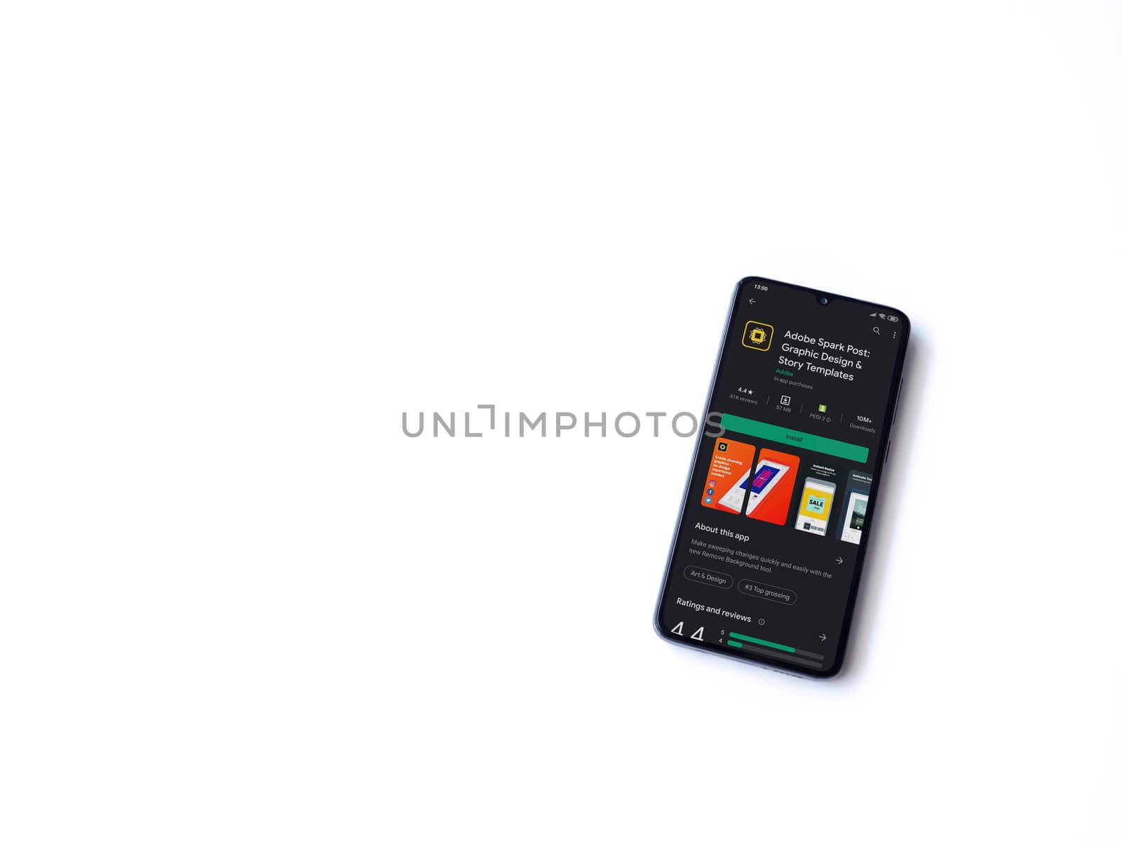 Lod, Israel - July 8, 2020: Adobe Spark Post - Graphic Design & Story Templates app play store page on the display of a black mobile smartphone on white background. Top view flat lay with copy space. 