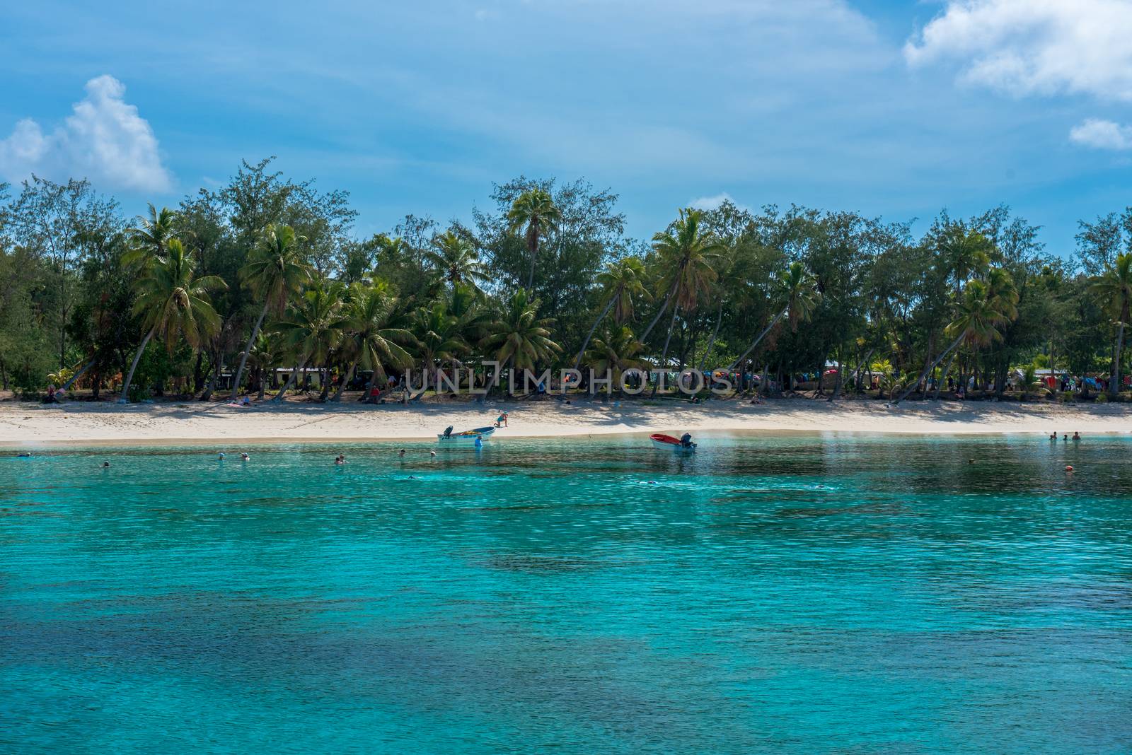 Fiji, The South Pacific -- February 7, 2016. Tourists visiting Fiji swim in the pristine aqua waters of the island on a beautiful summer day.