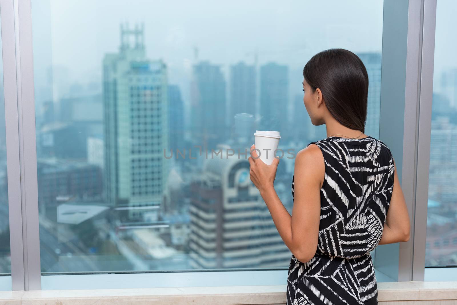 Business woman drinking coffee in office by Maridav