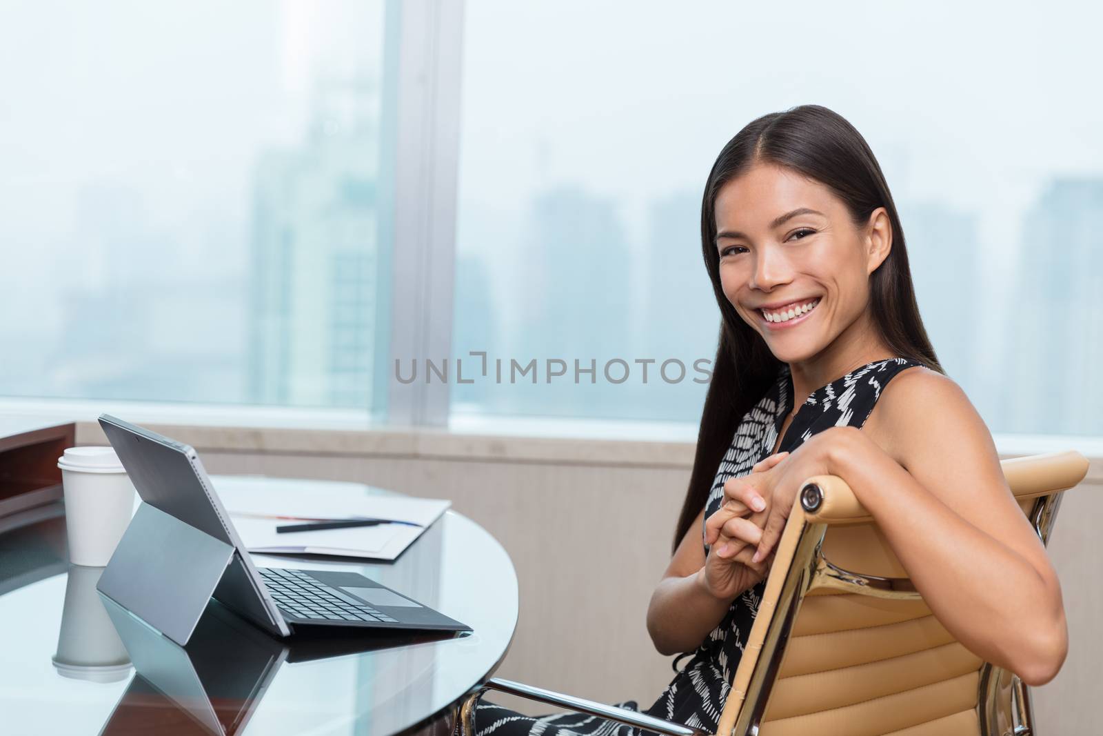Happy successful Asian young entrepreneur woman smiling portrait at home desk proud of her online startup business. Multiracial businesswoman.