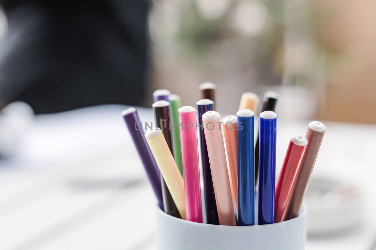 a group of colored markers in a plastic container. by rarrarorro