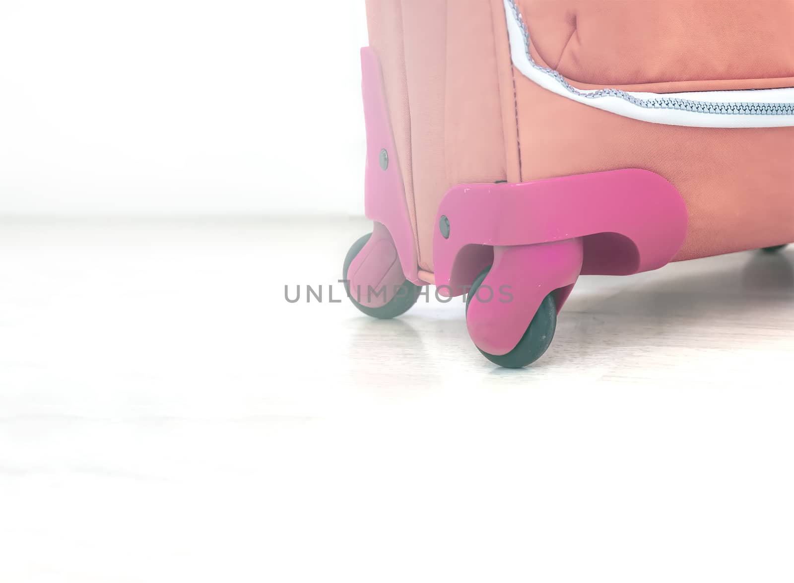 close up view of the wheels of a red suitcase. Travel and vacation concept.