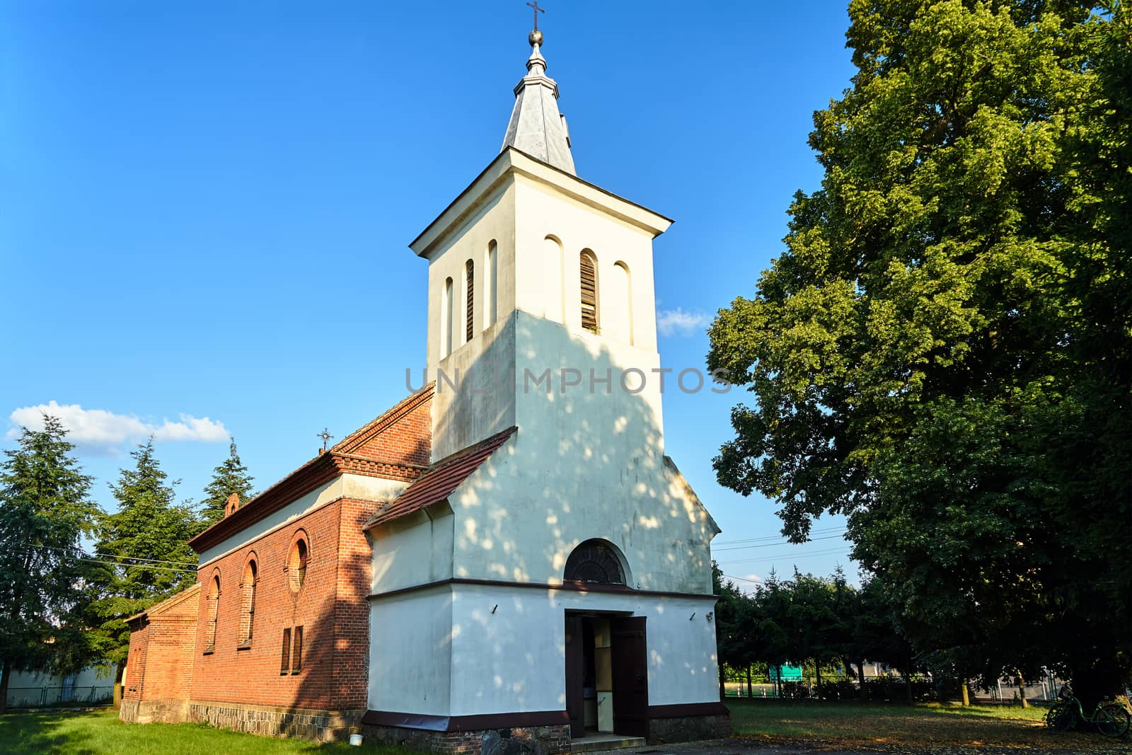 historic parish church with a bell tower in the village of Zemsko in Poland