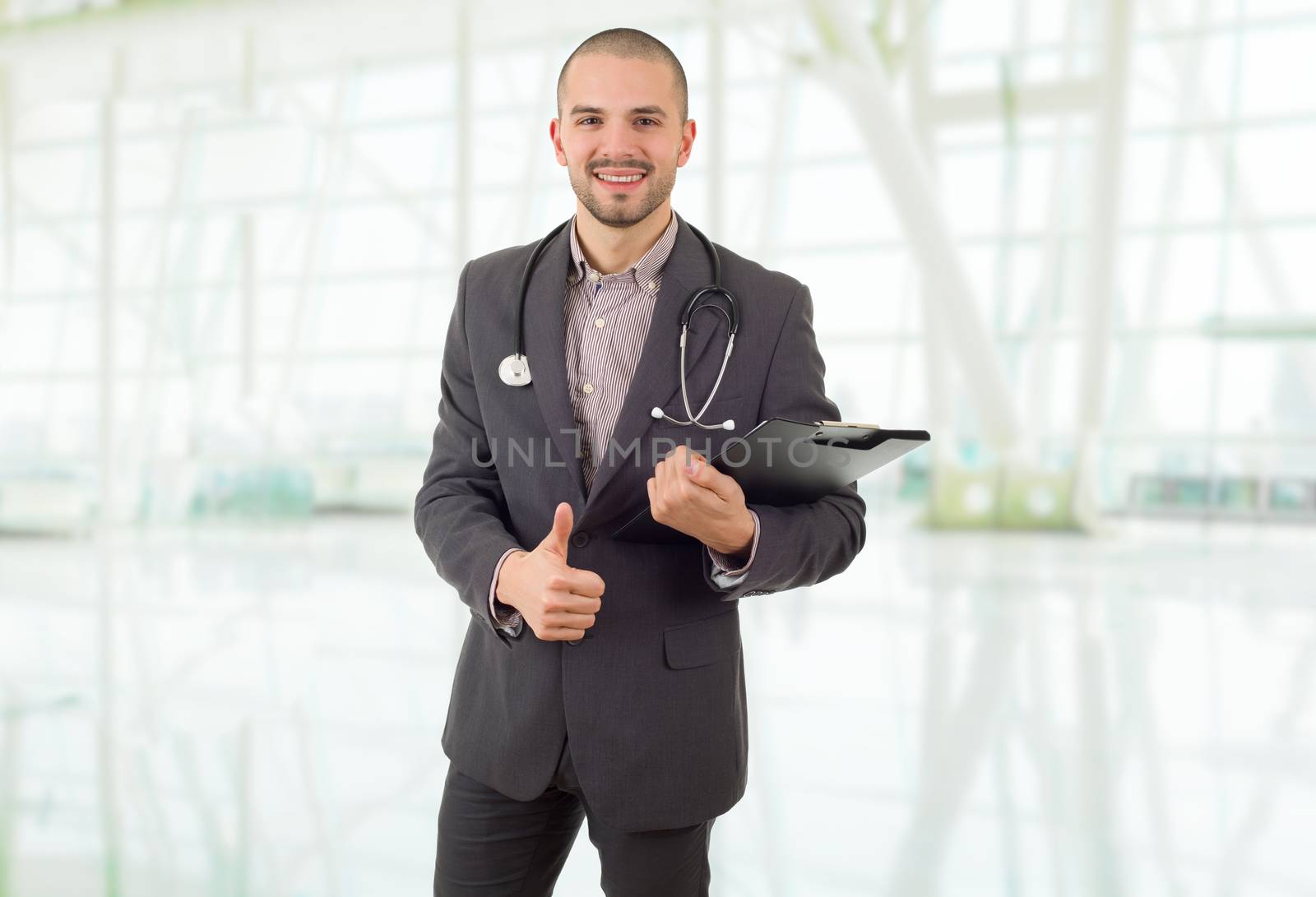 happy male doctor going thumb up, at the hospital