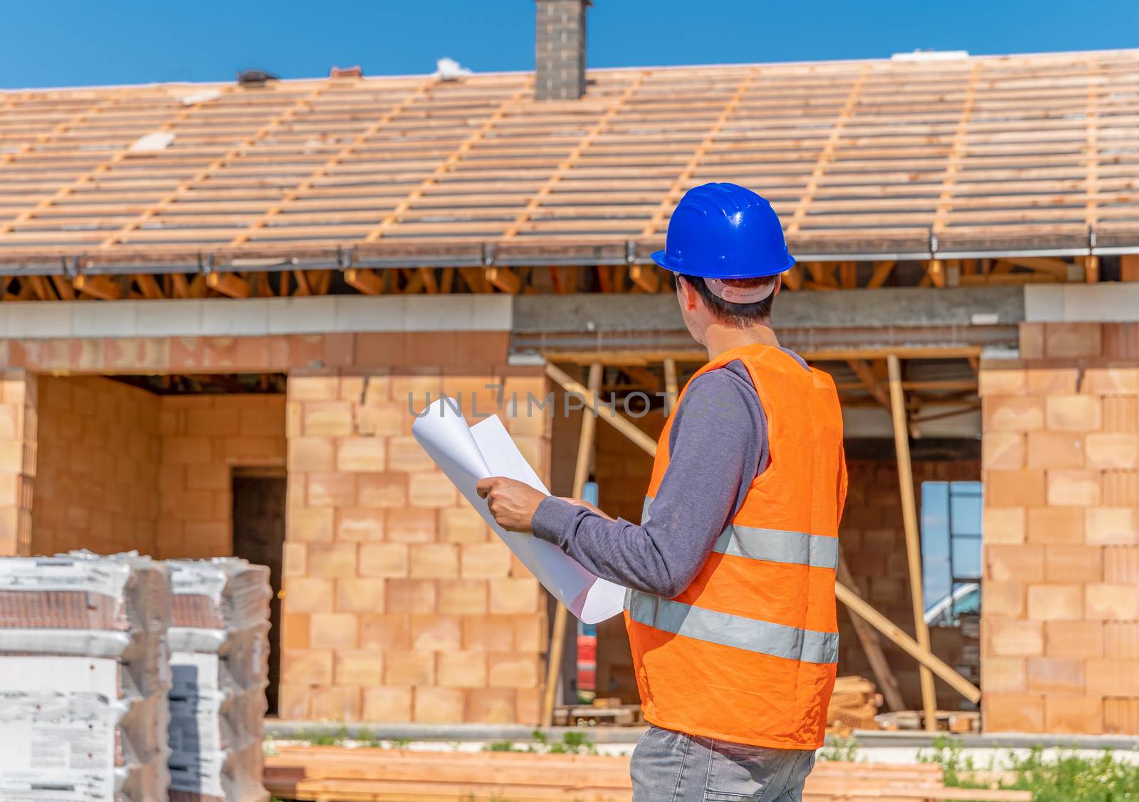 construction manager on the construction site of a family house by Edophoto