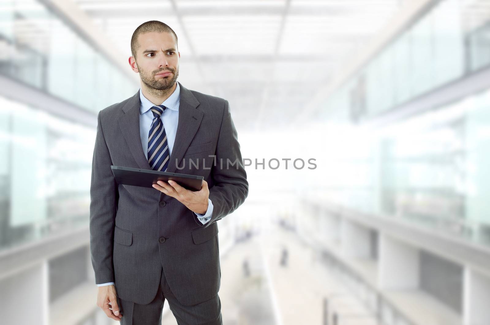 businessman bored with a tablet pc, at the office