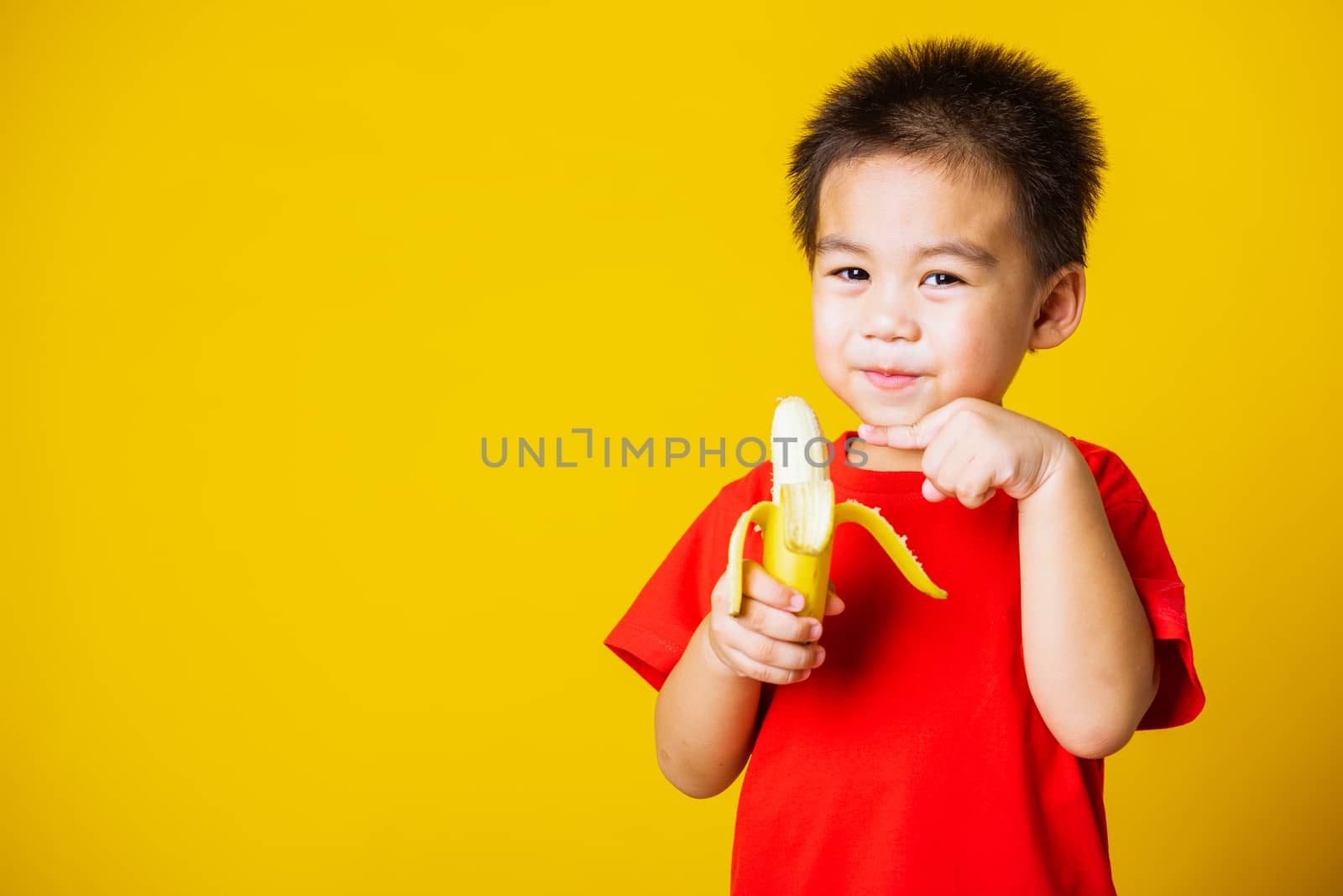 kid cute little boy attractive smile wearing red t-shirt playing by Sorapop