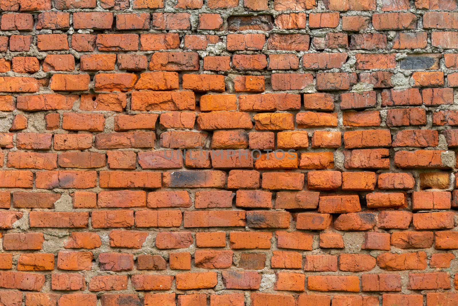 heavily weathered brick wall texture and background with deep water erosion.