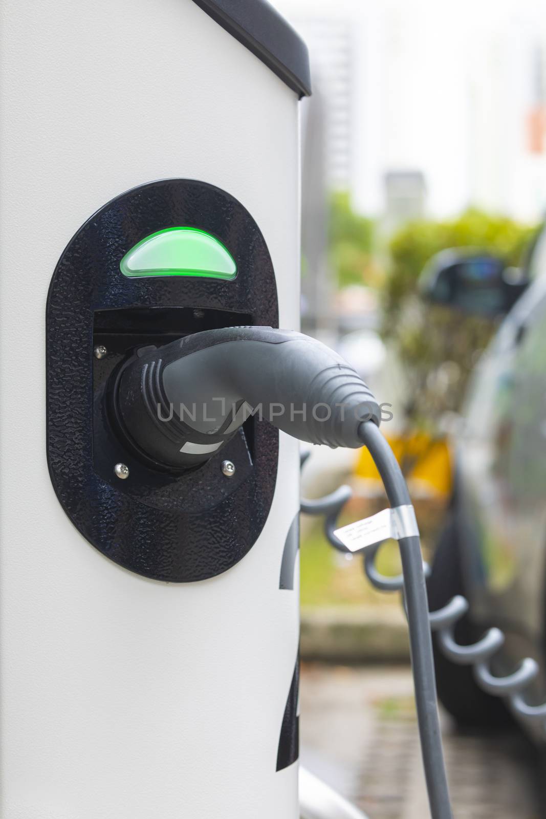 Electric car charging station at street level in Singapore, Southeast Asia. by alvarobueno